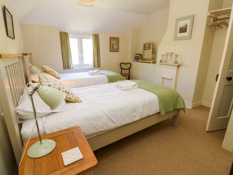 A bedroom with two beds and a window at Sweet Briars in Chale