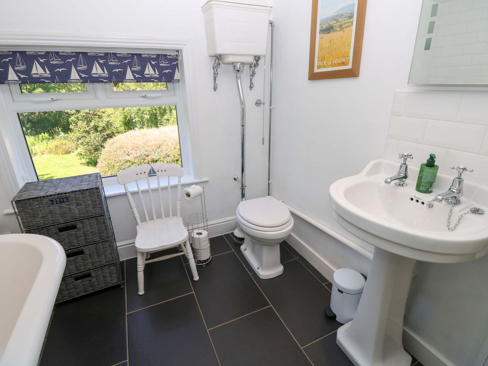 A bathroom with a sink, toilet, and storage unit at Sweet Briars in Chale