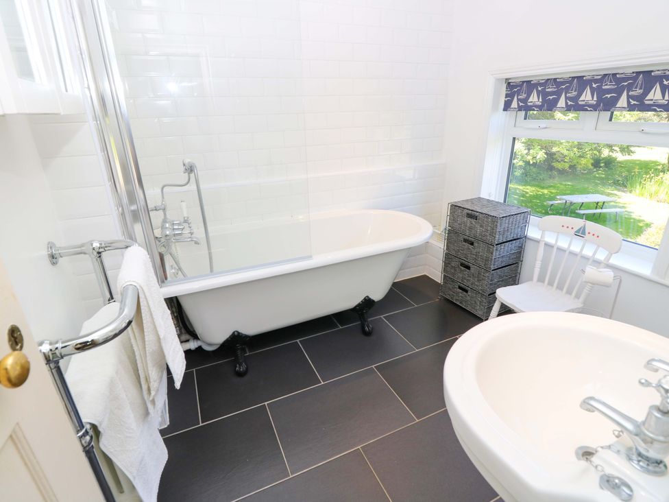 A bathroom with a bathtub and sink at Sweet Briars in Chale