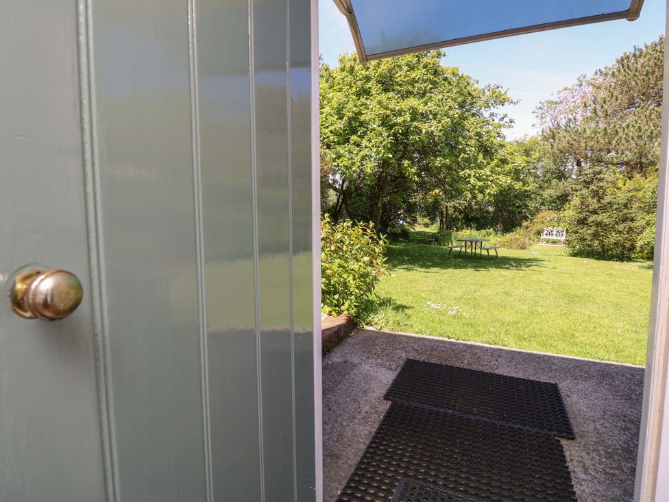 A view of a garden from an open door at Sweet Briars in Chale
