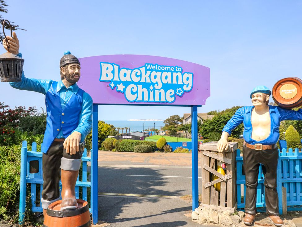 Welcome sign with sculptures at Blackgang Chine in Chale