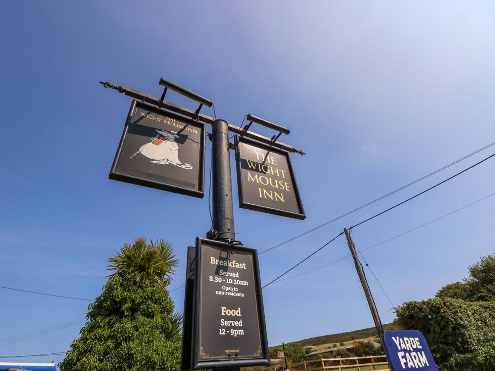 A sign for The Wight Mouse Inn with food details at Yarde Farm in Chale