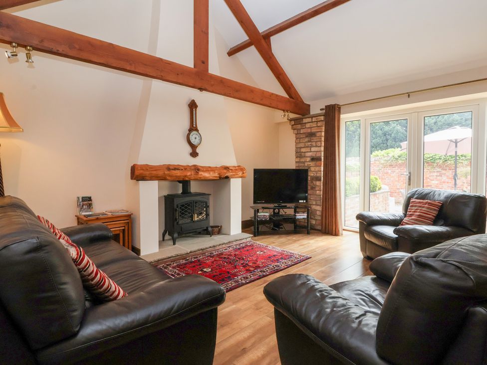 A living room with a fireplace and television at Winsall Court I Gransmoor near Bridlington