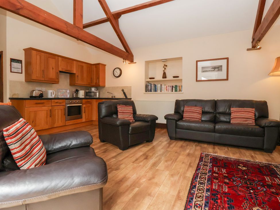 A living room with kitchen unit and sofas at Winsall Court I Gransmoor near Bridlington