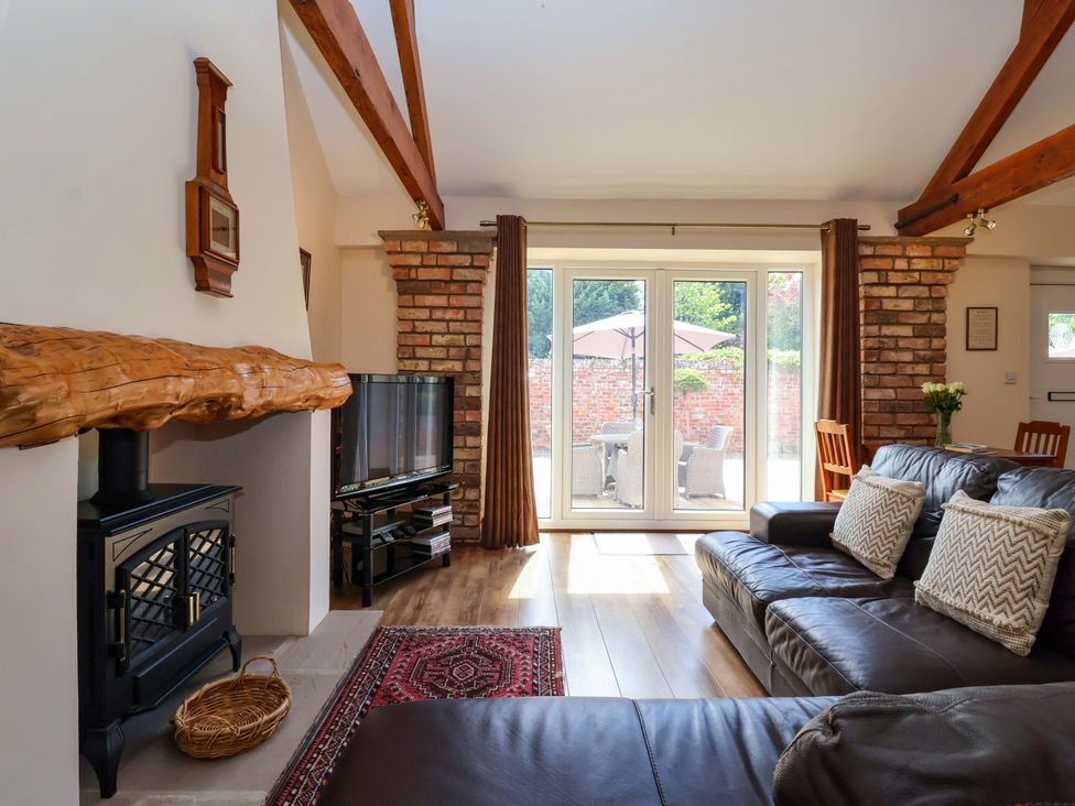 A living room with a sofa and television at Winsall Court II Gransmoor near Bridlington