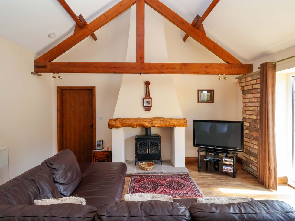 A living room with a fireplace and television at Winsall Court II Gransmoor near Bridlington