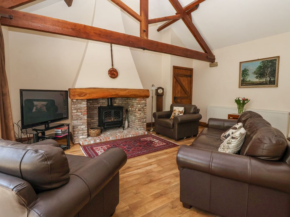 A living room with a fireplace and television at The Wagon Shed in Gransmoor near Bridlington