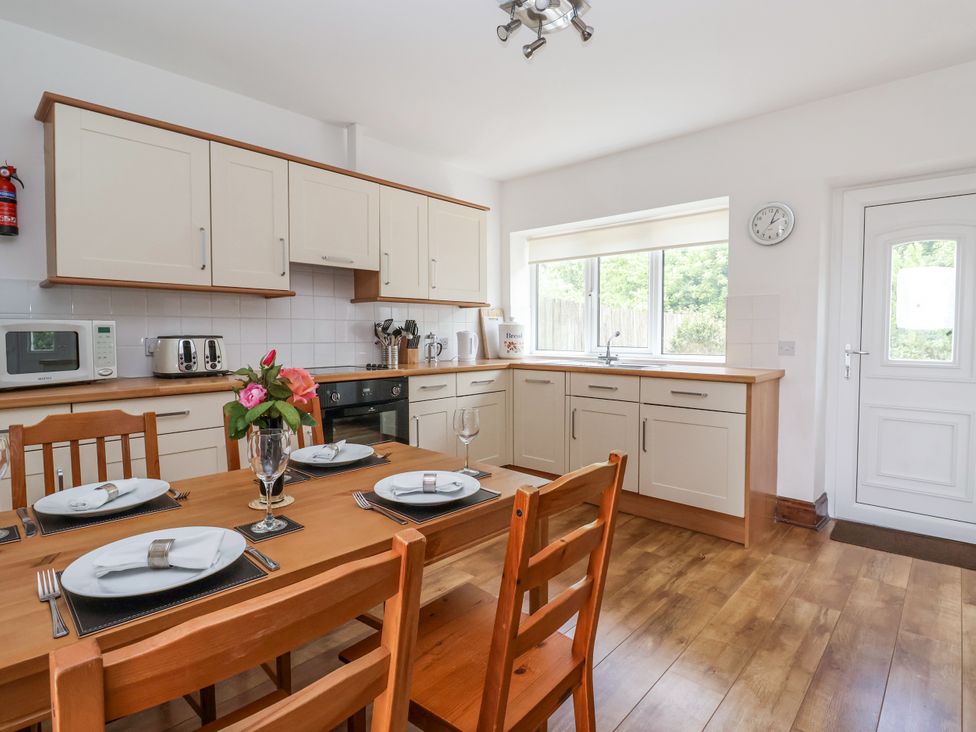 A kitchen with a dining table and chairs at The Wagon Shed Gransmoor near Bridlington
