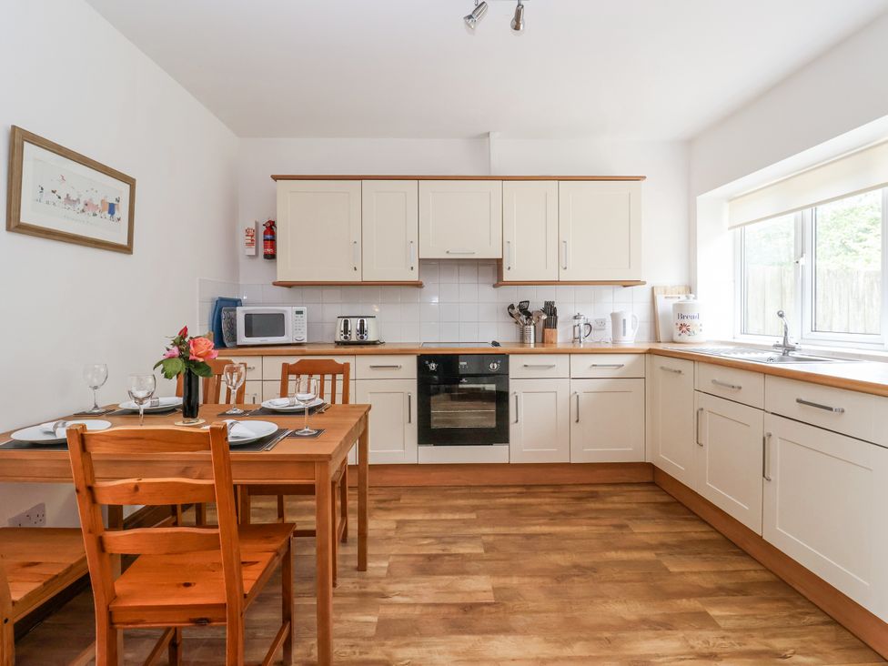 A kitchen with a dining table and chairs at The Wagon Shed in Gransmoor near Bridlington