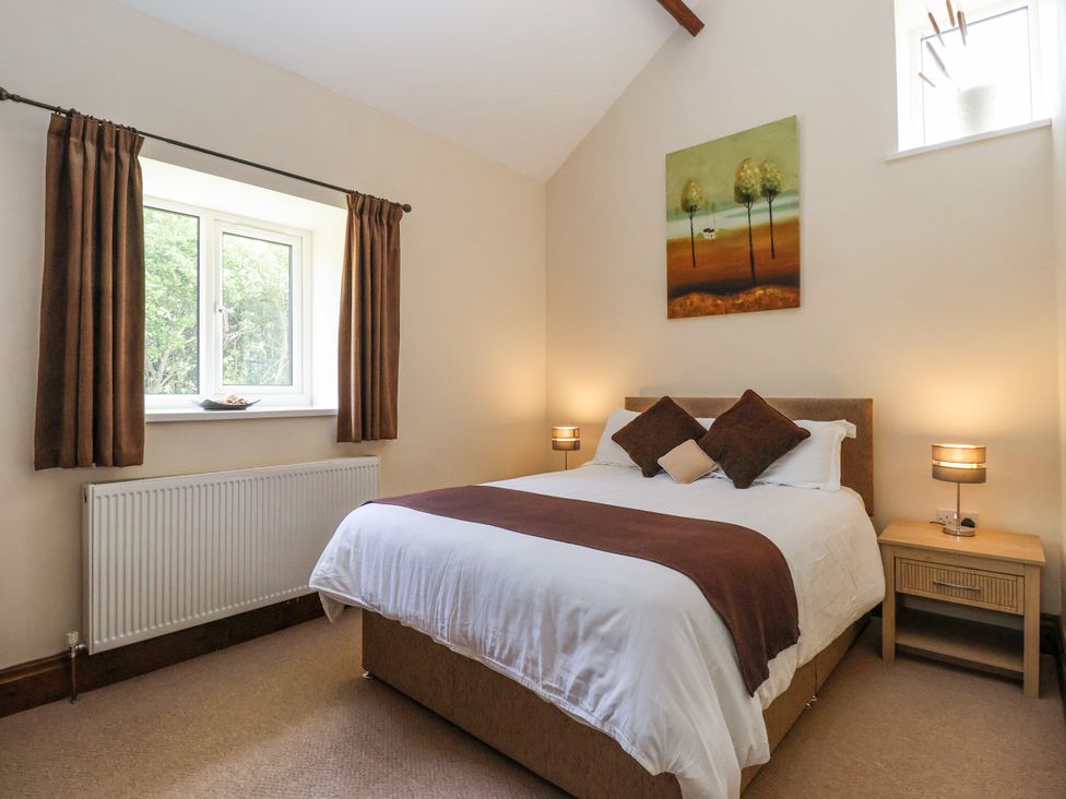 A bedroom with a bed and a window at The Wagon Shed in Gransmoor near Bridlington