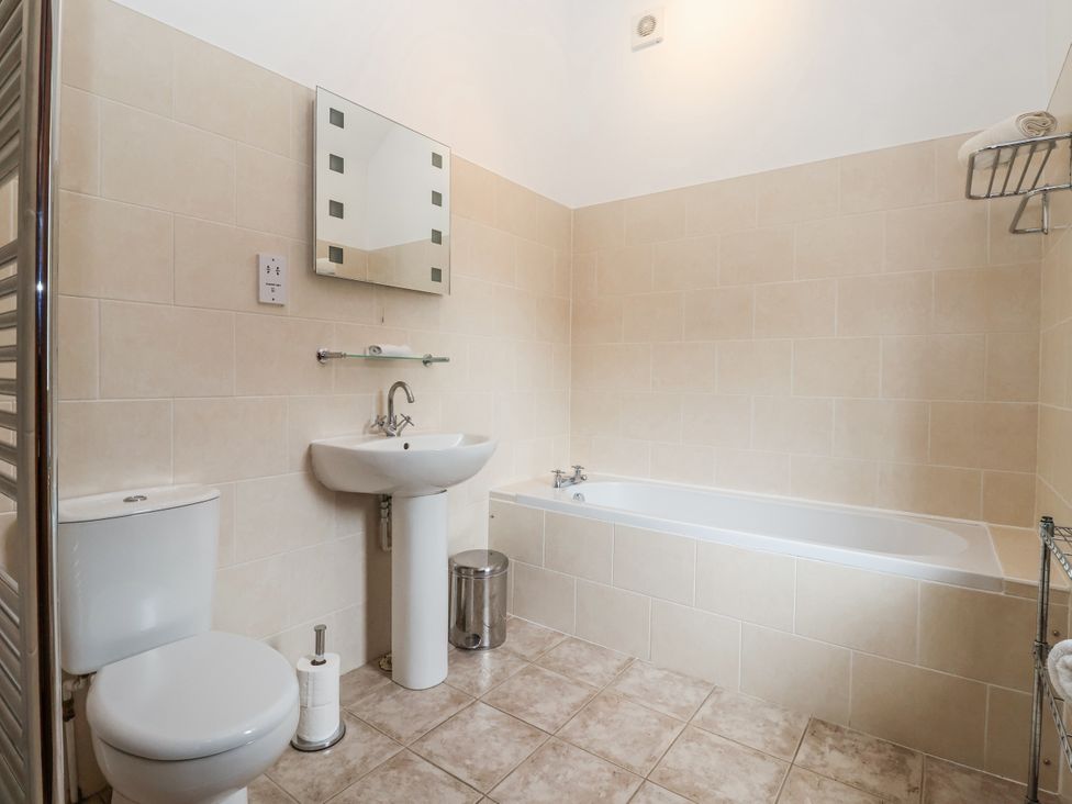 A bathroom with a sink, toilet, and bathtub at The Wagon Shed in Gransmoor near Bridlington