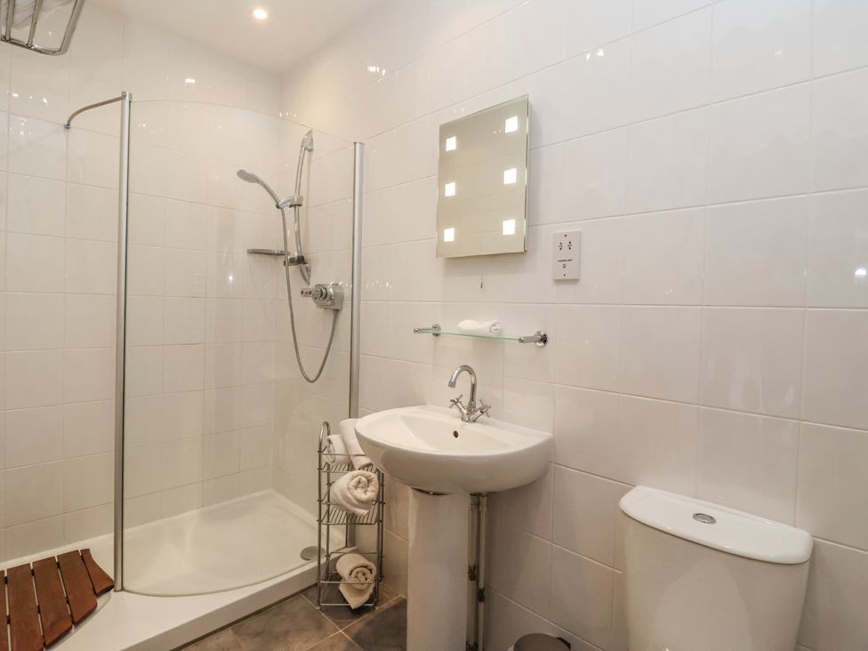 A bathroom with a shower, sink and toilet at The Wagon Shed in Gransmoor near Bridlington