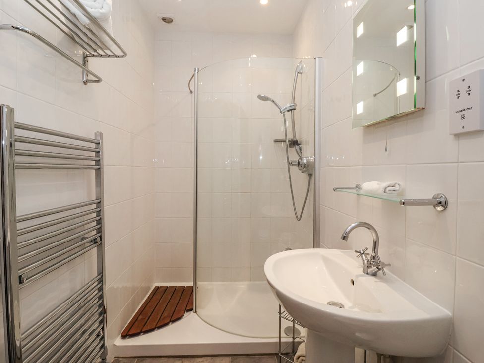 A bathroom with a shower and sink at The Wagon Shed in Gransmoor near Bridlington