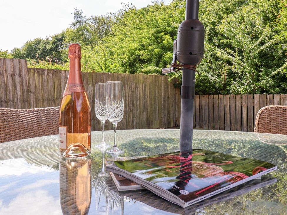A table with a bottle of wine and glasses at The Wagon Shed Gransmoor near Bridlington