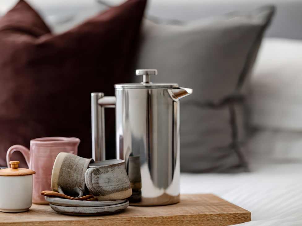 A coffee pot and cups on a tray in the bedroom at Bridge End Cottage Stainforth