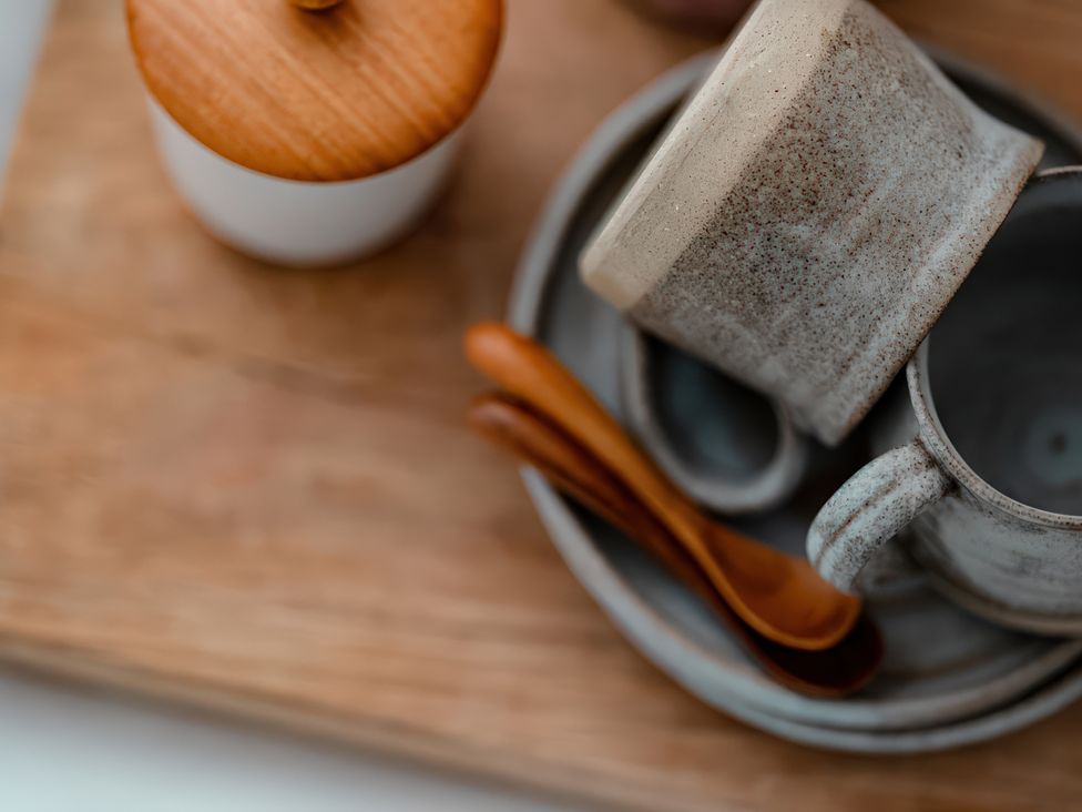 Kitchen items including a cup, saucer, and spoon at Bridge End Cottage Stainforth
