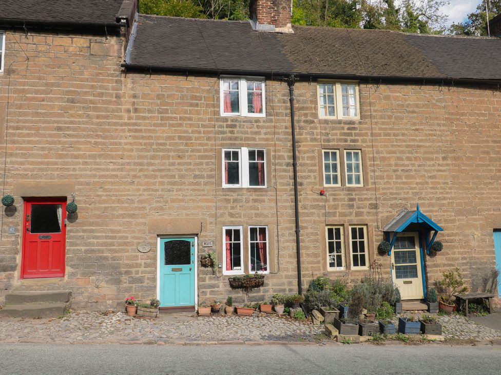 A row of houses with red and blue doors at 40 Water Lane, Matlock