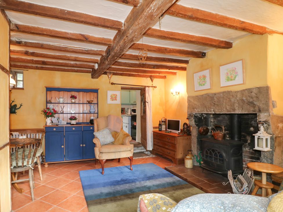 A living room with a fireplace and cupboards at 40 Water Lane in Matlock