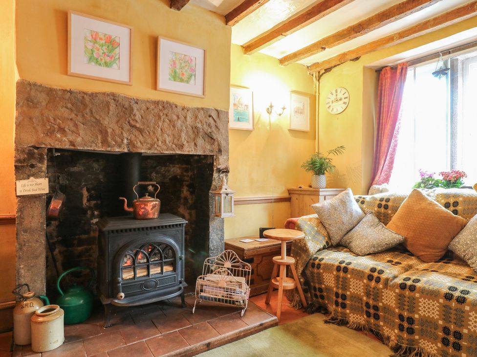 A living room with a fireplace and couch at 40 Water Lane Matlock