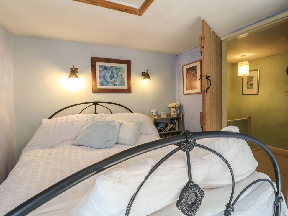 A bedroom with a bed and wall art at 40 Water Lane Matlock