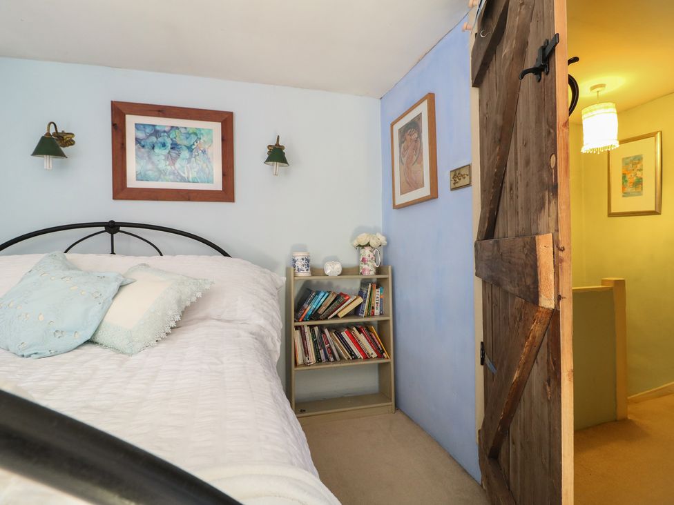 A bedroom with a bed and bookshelf at 40 Water Lane Matlock