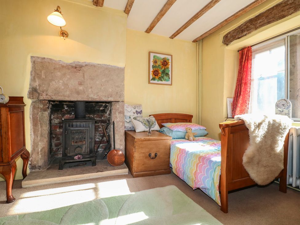 A bedroom with a bed and a fireplace at 40 Water Lane Matlock
