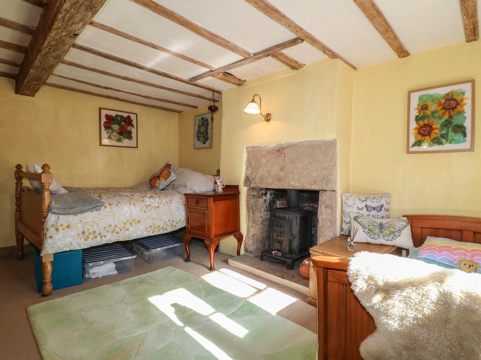 A bedroom with a bed and fireplace at 40 Water Lane Matlock