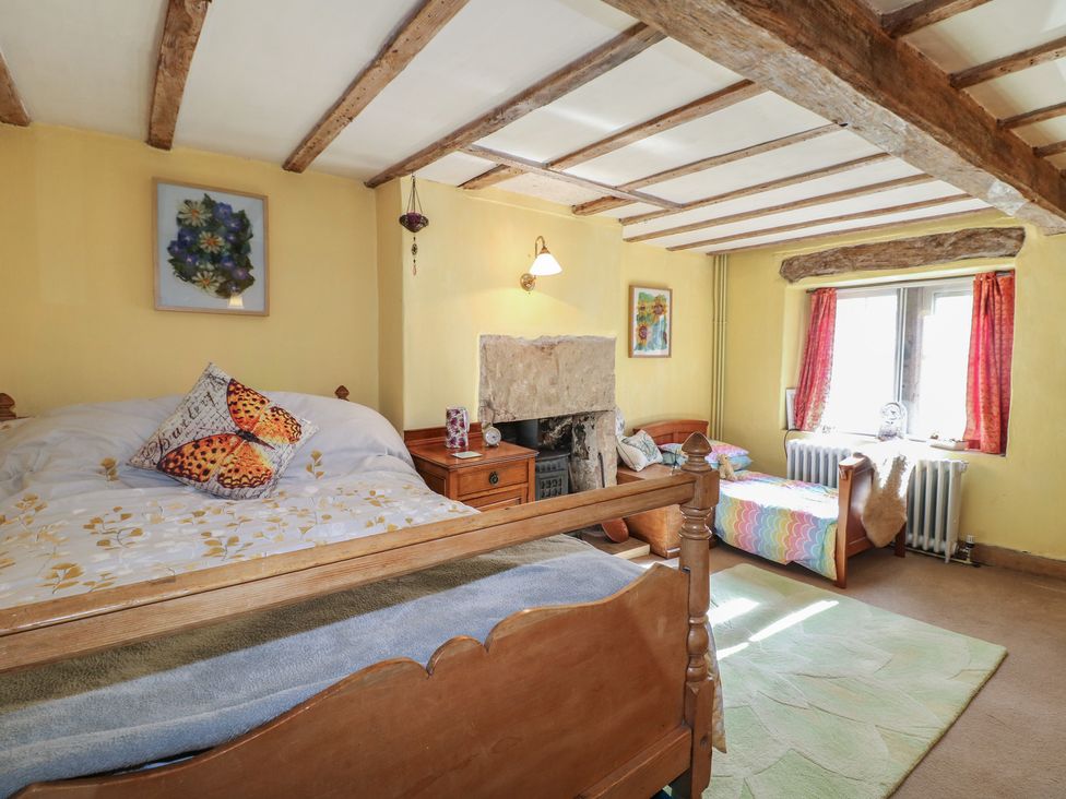 A bedroom with a bed and fireplace at 40 Water Lane Matlock