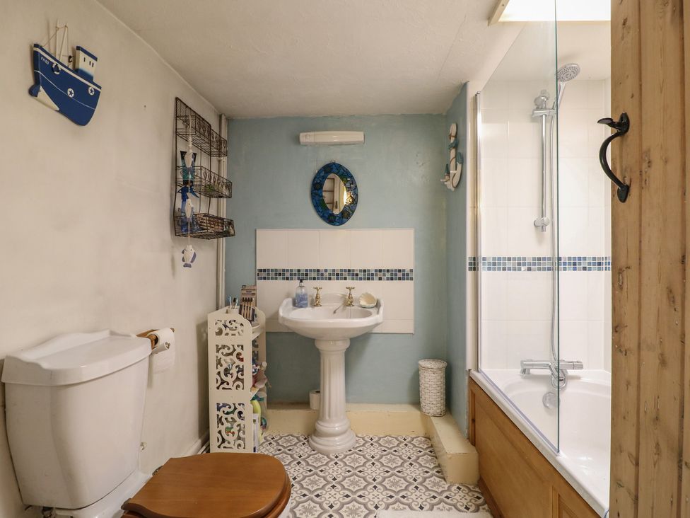 A bathroom with a sink, shower, and toilet at 40 Water Lane Matlock