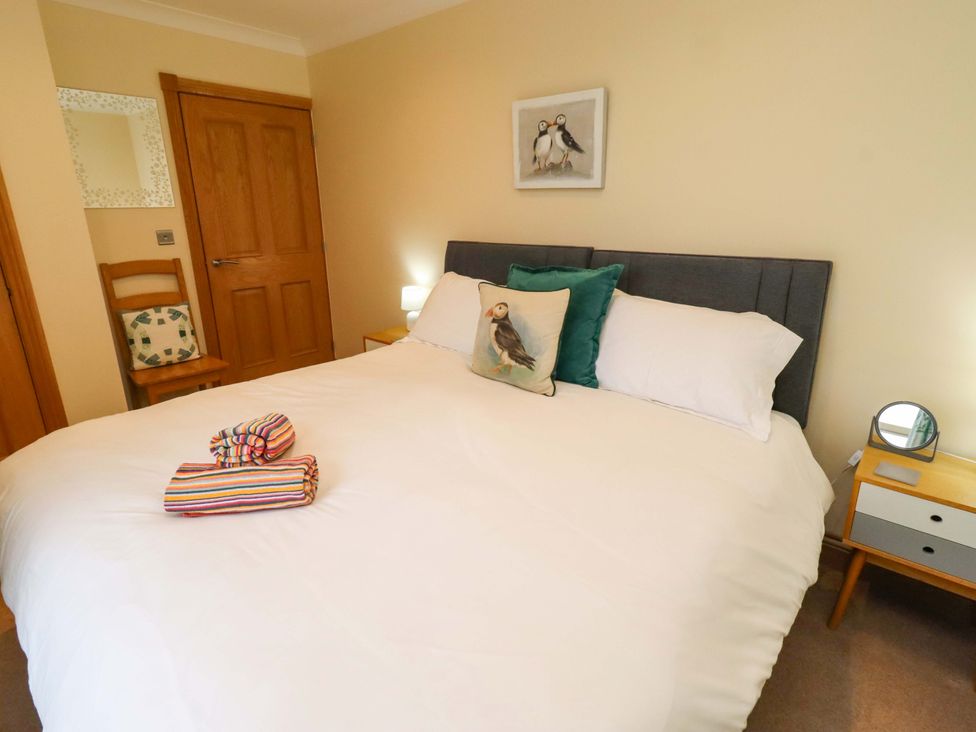 A bedroom with a double bed and nightstands at Bank Top Cottage in Embleton