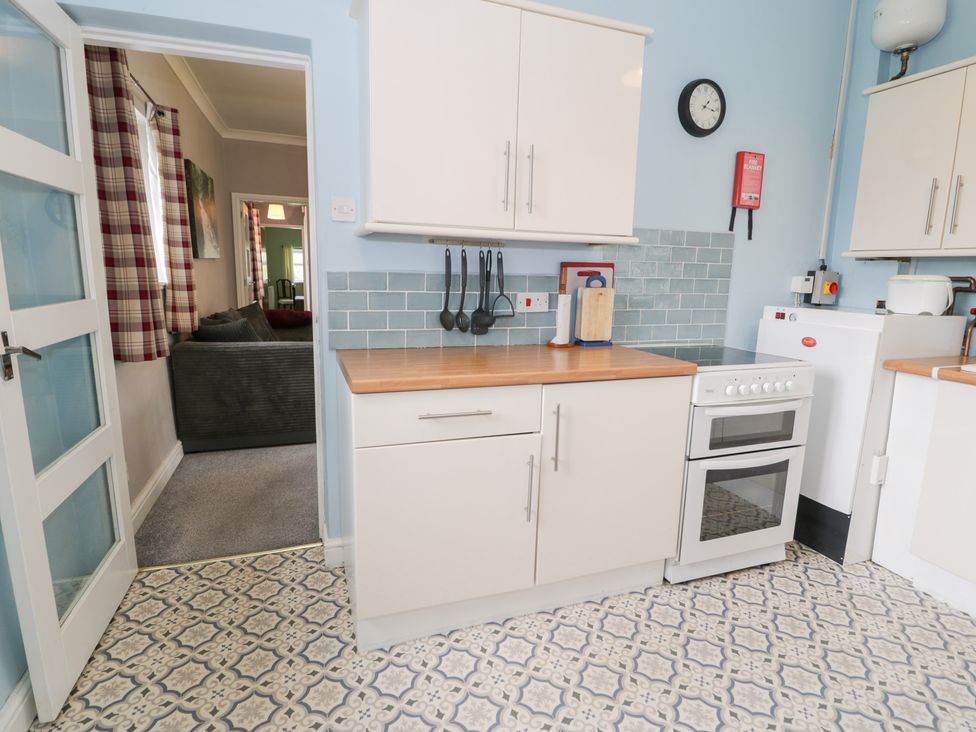 A kitchen with stove and units at Dyffryn Bach Glan-yr-afon near Corwen