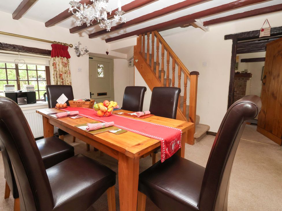 A dining room with a table and chairs at Clara's Cottage in West Lutton near Malton
