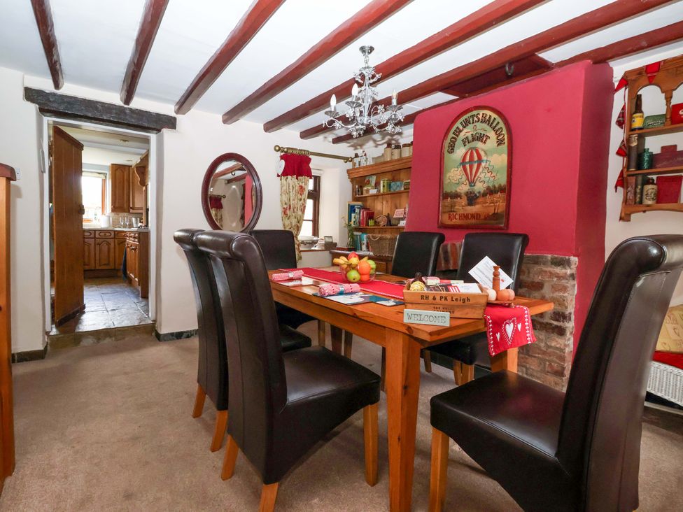 A dining room with a table and chairs at Clara's Cottage in West Lutton near Malton
