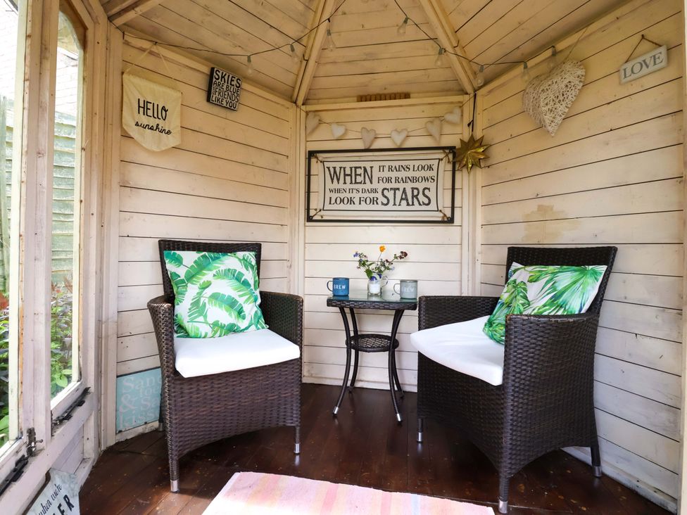 A snug with seating and decorative signs at Clara's Cottage in West Lutton near Malton
