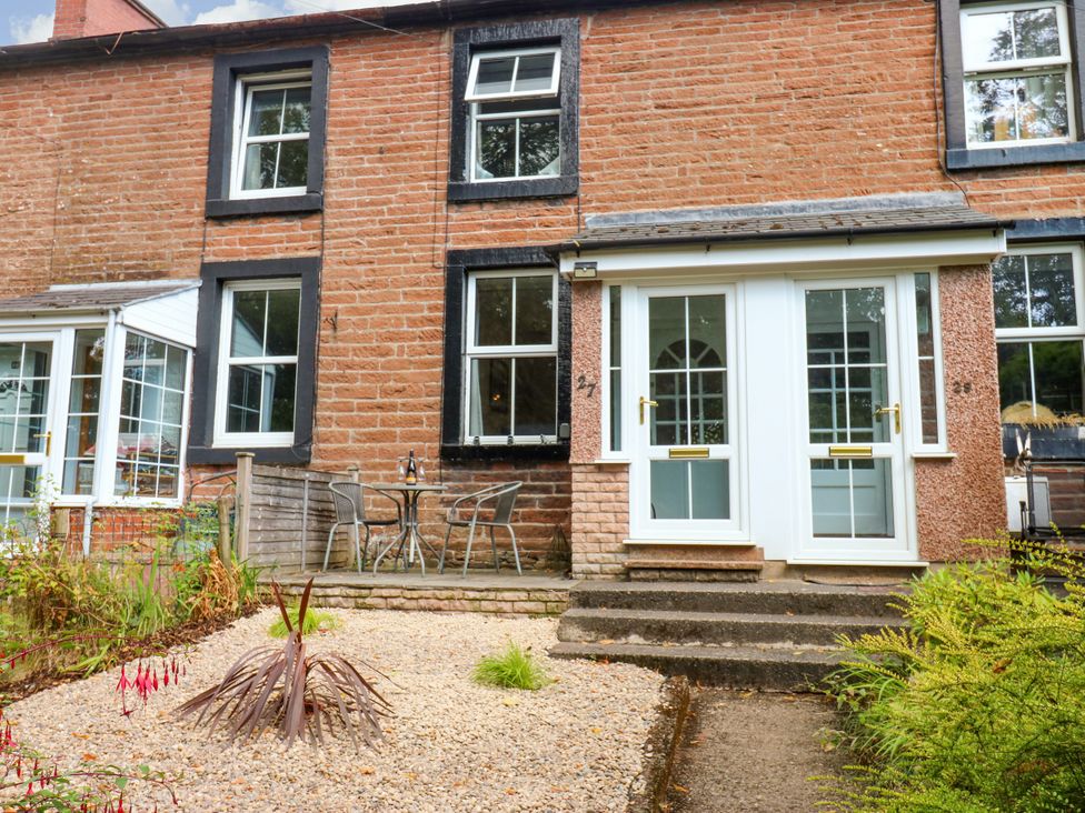 An outdoor area with a house's entrance and seating at 27 Bongate Appleby-In-Westmorland