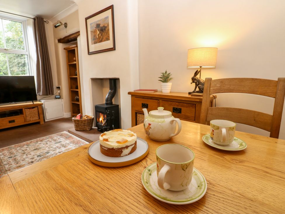 A living room with a table set for tea at 27 Bongate in Appleby-In-Westmorland