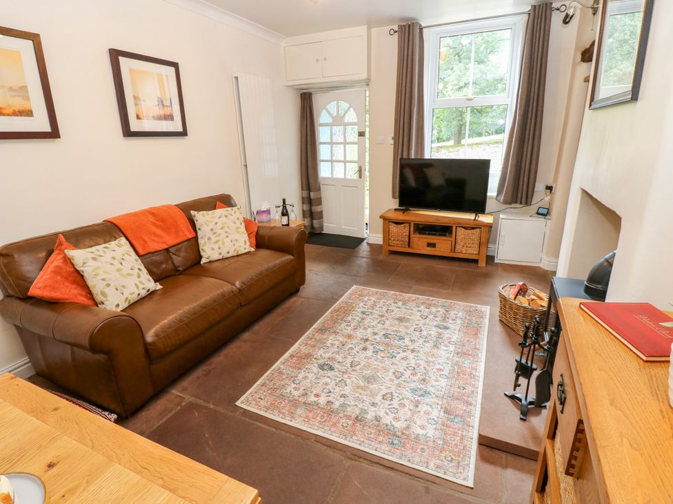 A living room with a sofa and television at 27 Bongate in Appleby-In-Westmorland