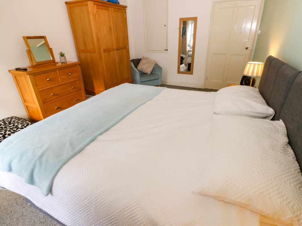 A bedroom with a bed and wooden furniture at 27 Bongate in Appleby-In-Westmorland