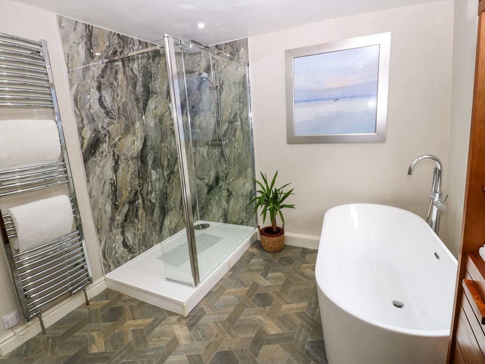 A bathroom with a shower and bathtub at 27 Bongate in Appleby-In-Westmorland