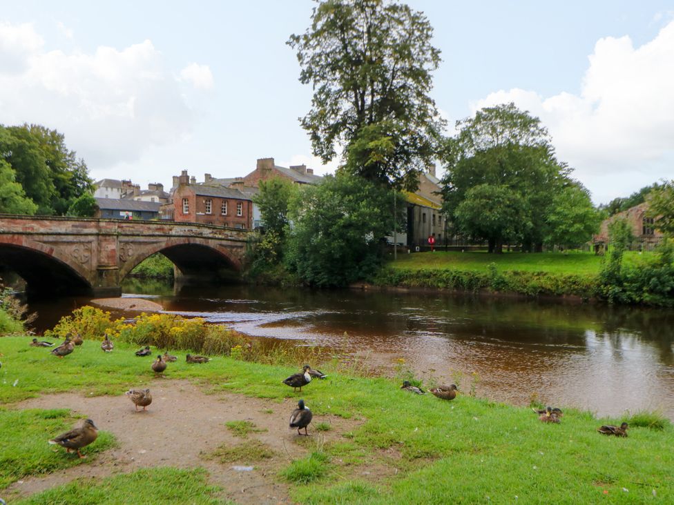 A bridge over a river with ducks and grass at 27 Bongate in Appleby-In-Westmorland