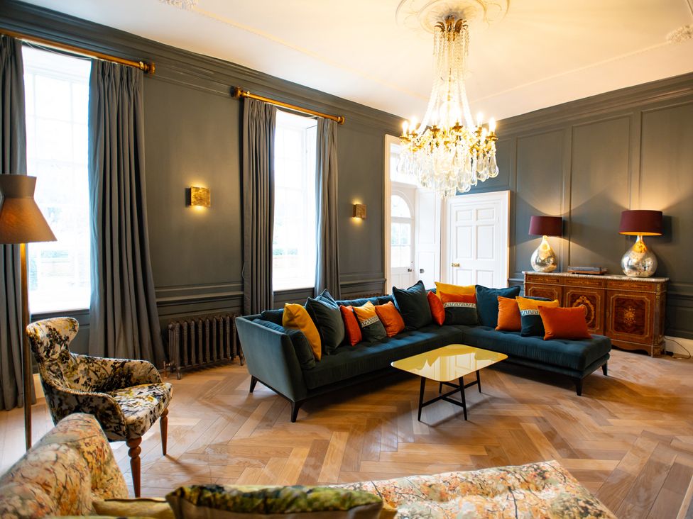 A living room with a sofa and coffee table at Wren Place Hall in Worsbrough