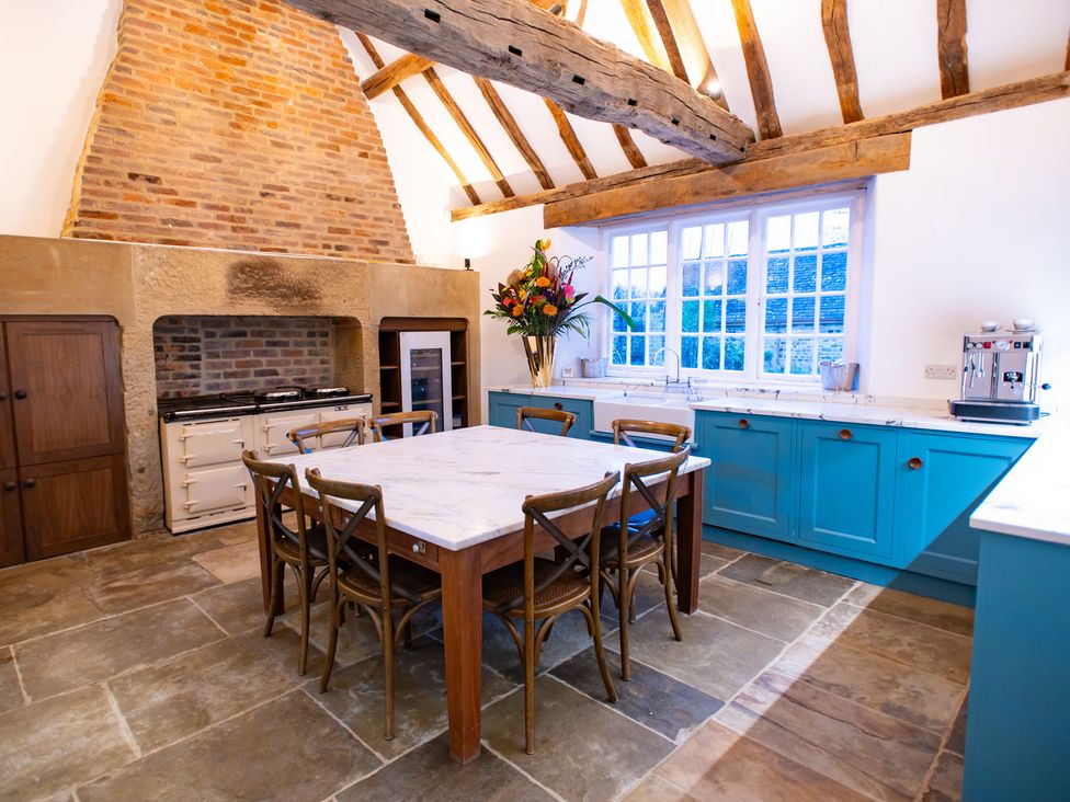 A kitchen with a dining table and chairs at Wren Place Hall in Worsbrough