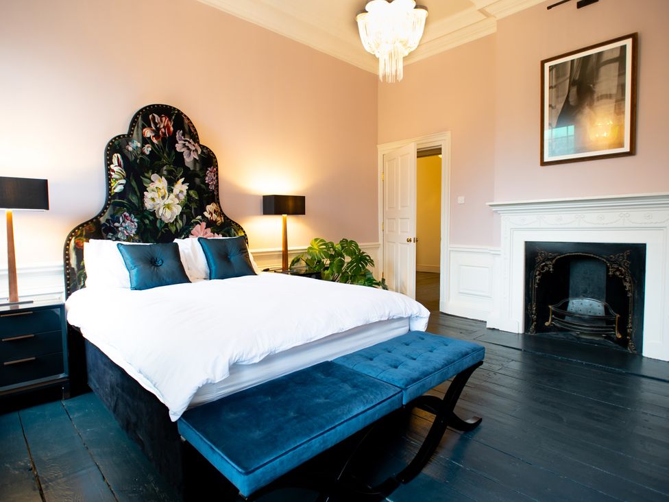 A bedroom with a bed and lamps at Wren Place Hall in Worsbrough