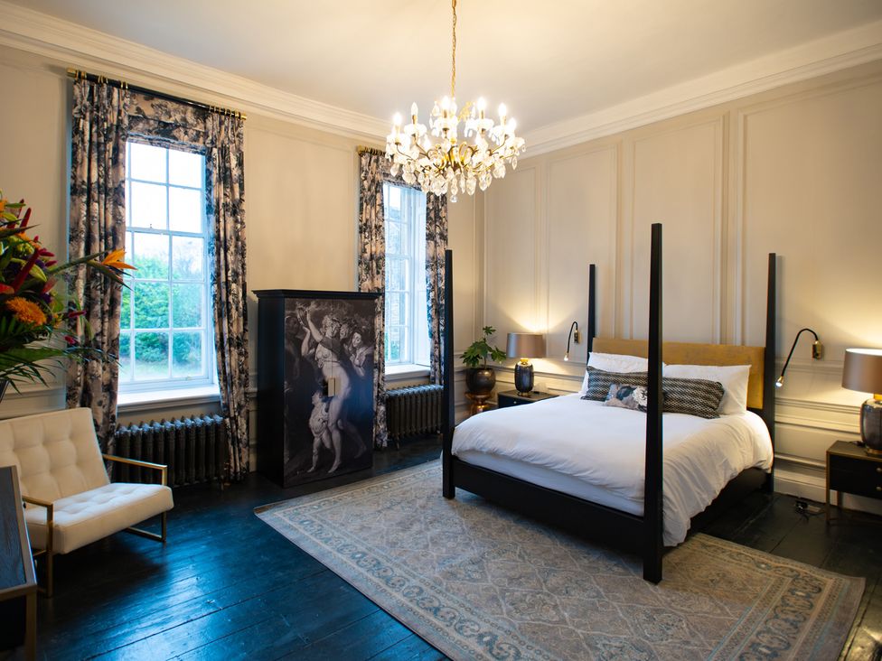 A bedroom with a bed and wardrobe at Wren Place Hall in Worsbrough