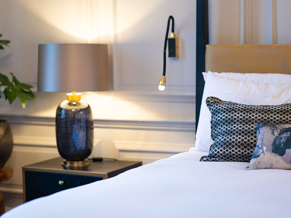 A bedroom with a bed and bedside table at Wren Place Hall, Worsbrough