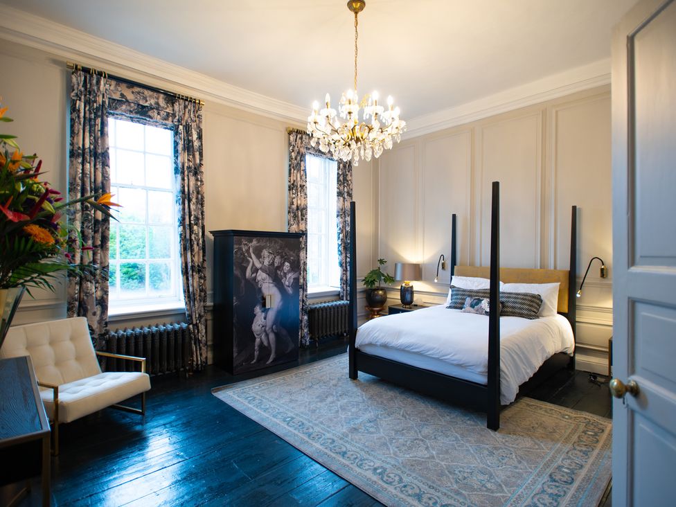 A bedroom with a bed and wardrobe at Wren Place Hall in Worsbrough