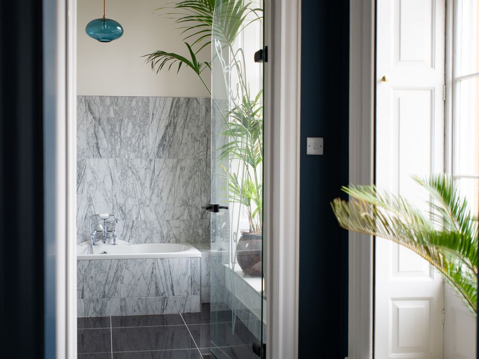 A bathroom with a bathtub and plants visible at Wren Place Hall in Worsbrough