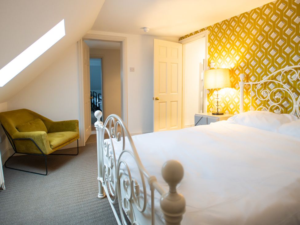 A bedroom with a bed and lamp at Wren Place Hall in Worsbrough