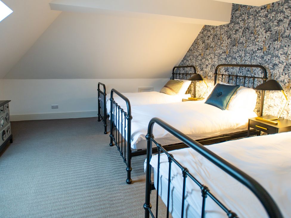 A bedroom with two beds and lamps at Wren Place Hall in Worsbrough