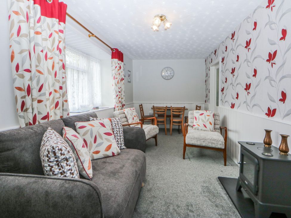 A living room with a sofa and dining table at Ground Floor Apartment in Tremadog